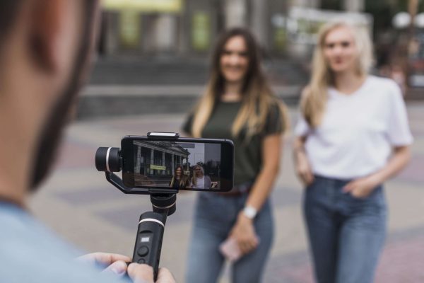 Man Photographing Women With Phone